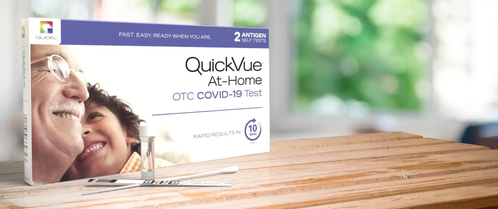 QuickVue At-Home OTC COVID-19 Test in packaging. Rapid results in 10 minutes.